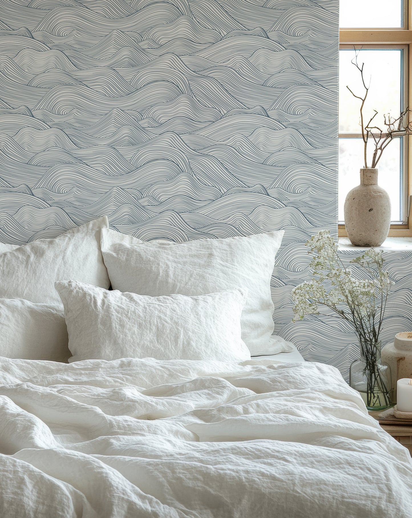 a bed with a white comforter and pillows