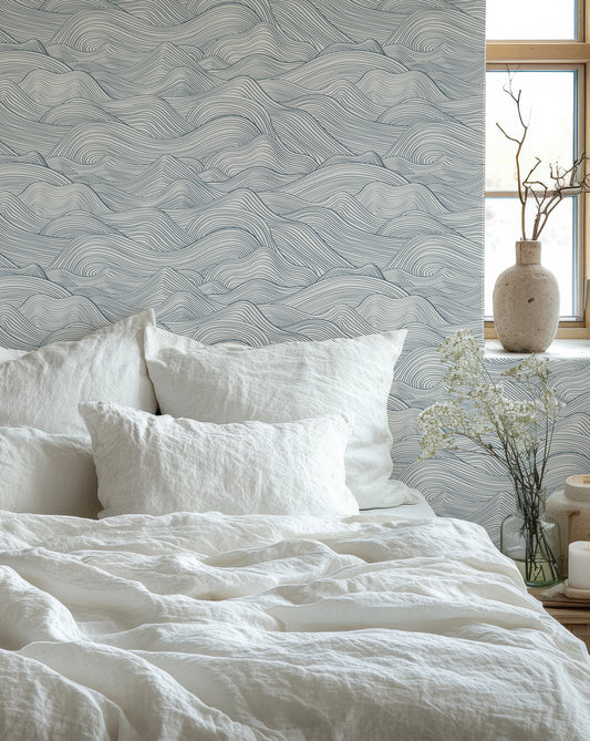 a bed with a white comforter and pillows