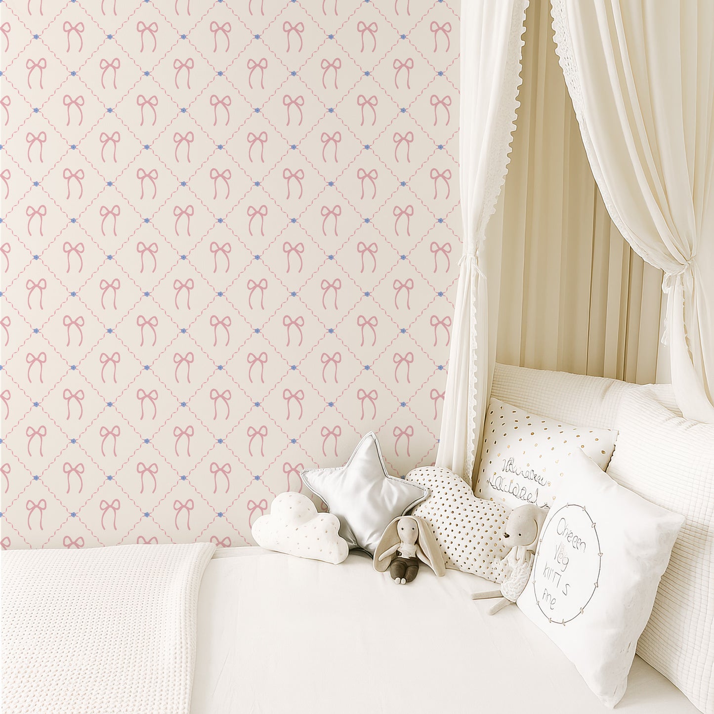 a cozy and charming bedroom scene with a canopy bed, white bedding, and a wallpapered wall with a repeating pattern of pink bows. The bed is adorned with white pillows and a stuffed animal, creating a warm and inviting atmosphere.