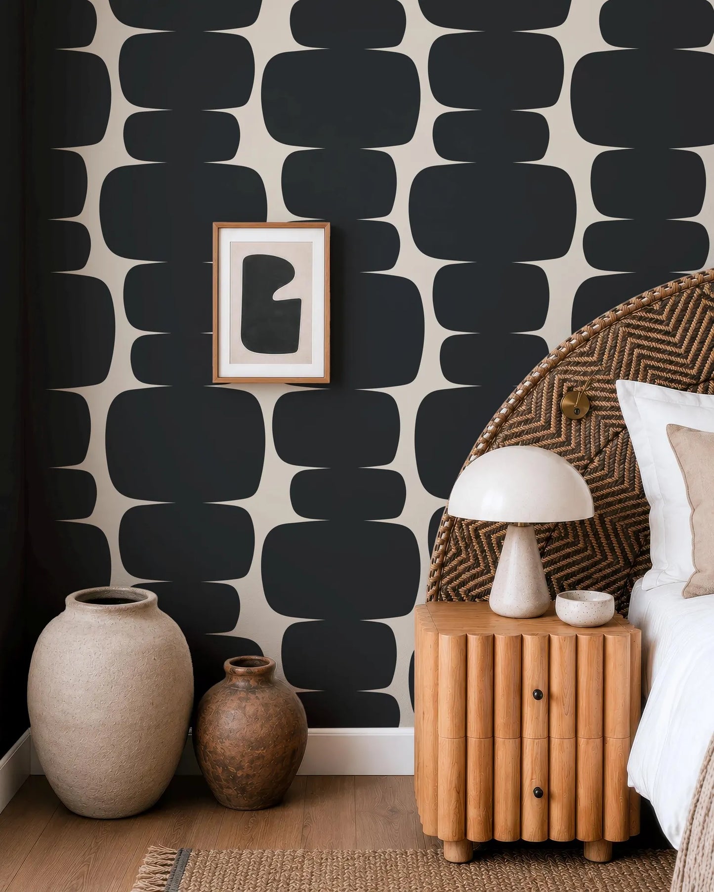 a modern bedroom with a black and white geometric wallpaper, a wooden headboard, and a wooden nightstand with a lamp.