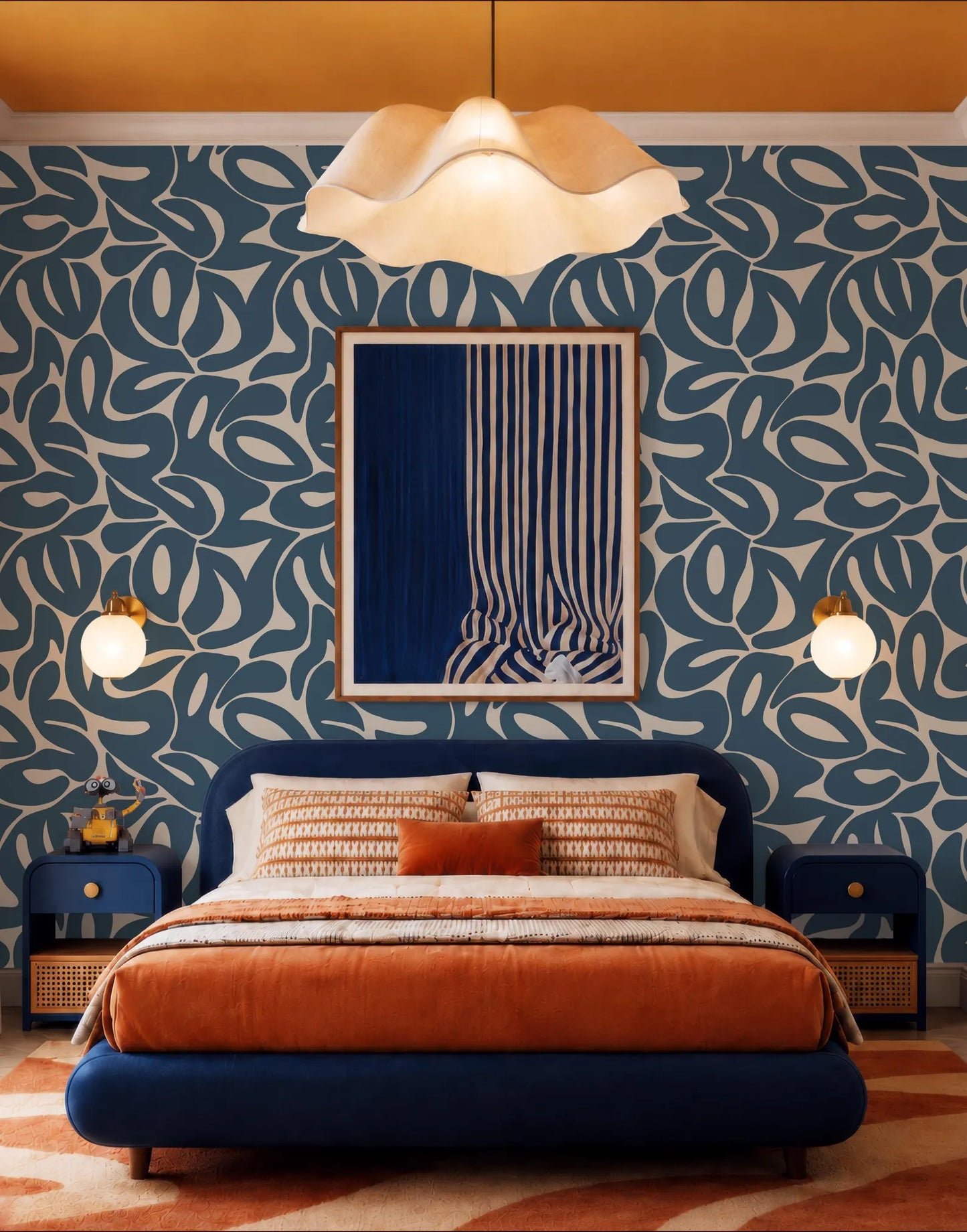 a modern bedroom with a large bed, a blue headboard, and a striking blue and white abstract painting on the wall. The room features a mix of blue and orange decor, with a patterned rug and a chandelier providing a warm and inviting atmosphere.