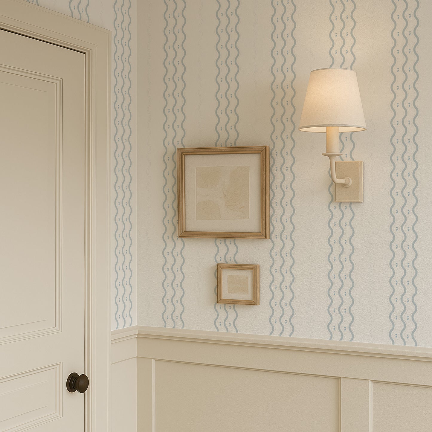 a corner of a room with a framed picture on the wall, a wall lamp, and a door.