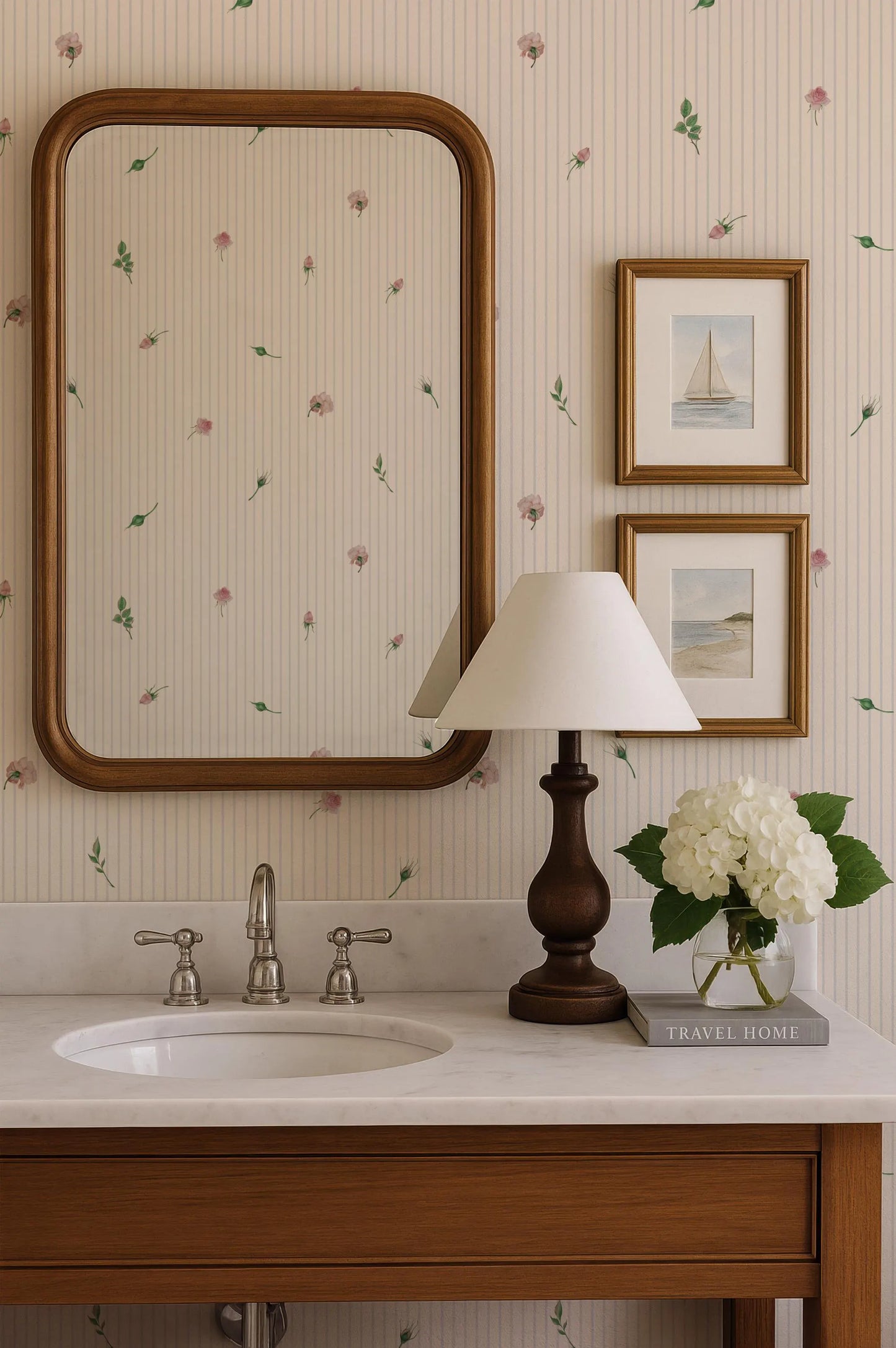a bathroom vanity with a white sink, a wooden cabinet, a lamp, a mirror, and a framed picture of a sailboat.
