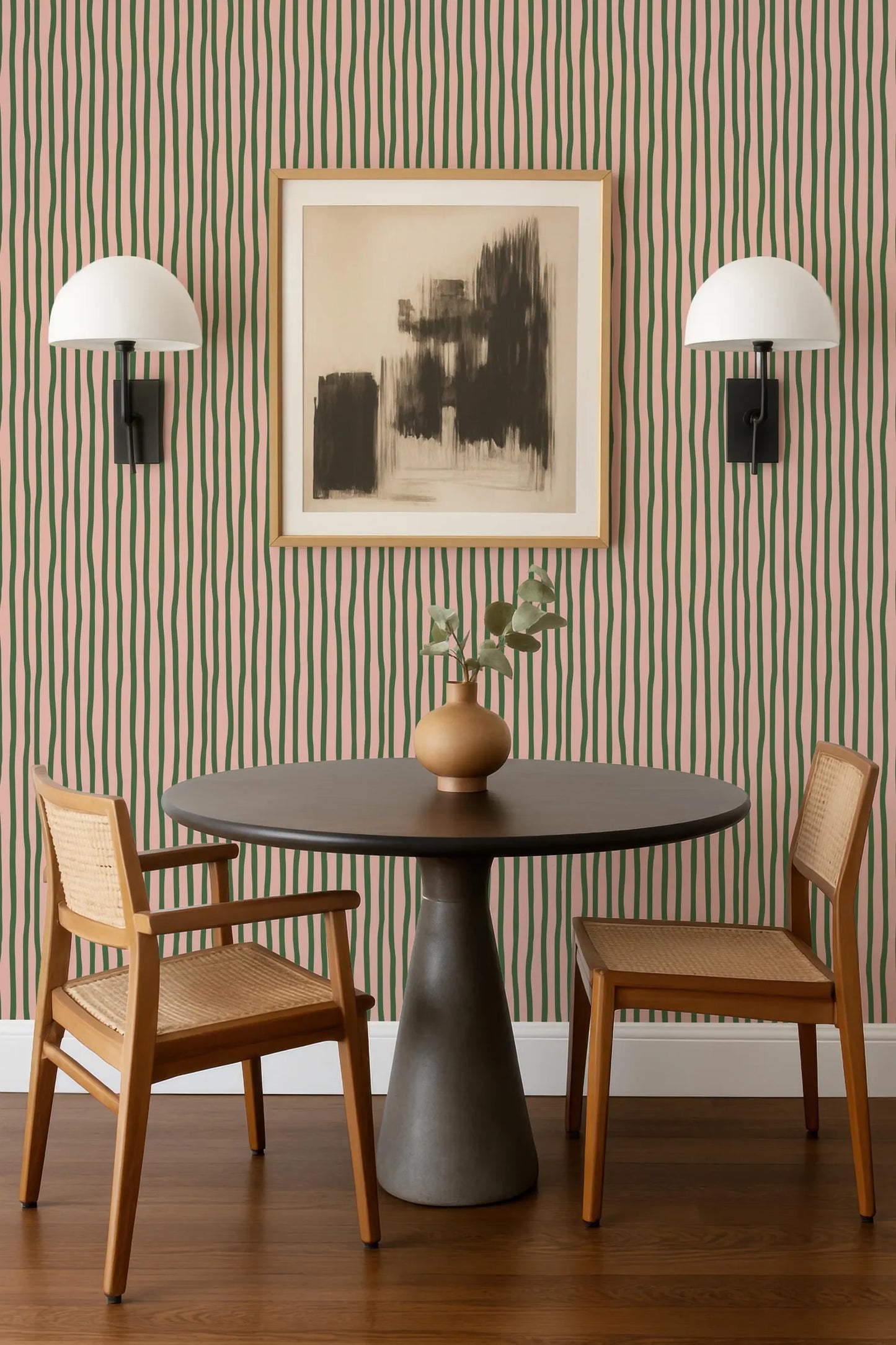 a modern dining area with a round table, two wooden chairs, and a framed abstract artwork on the wall above the table.