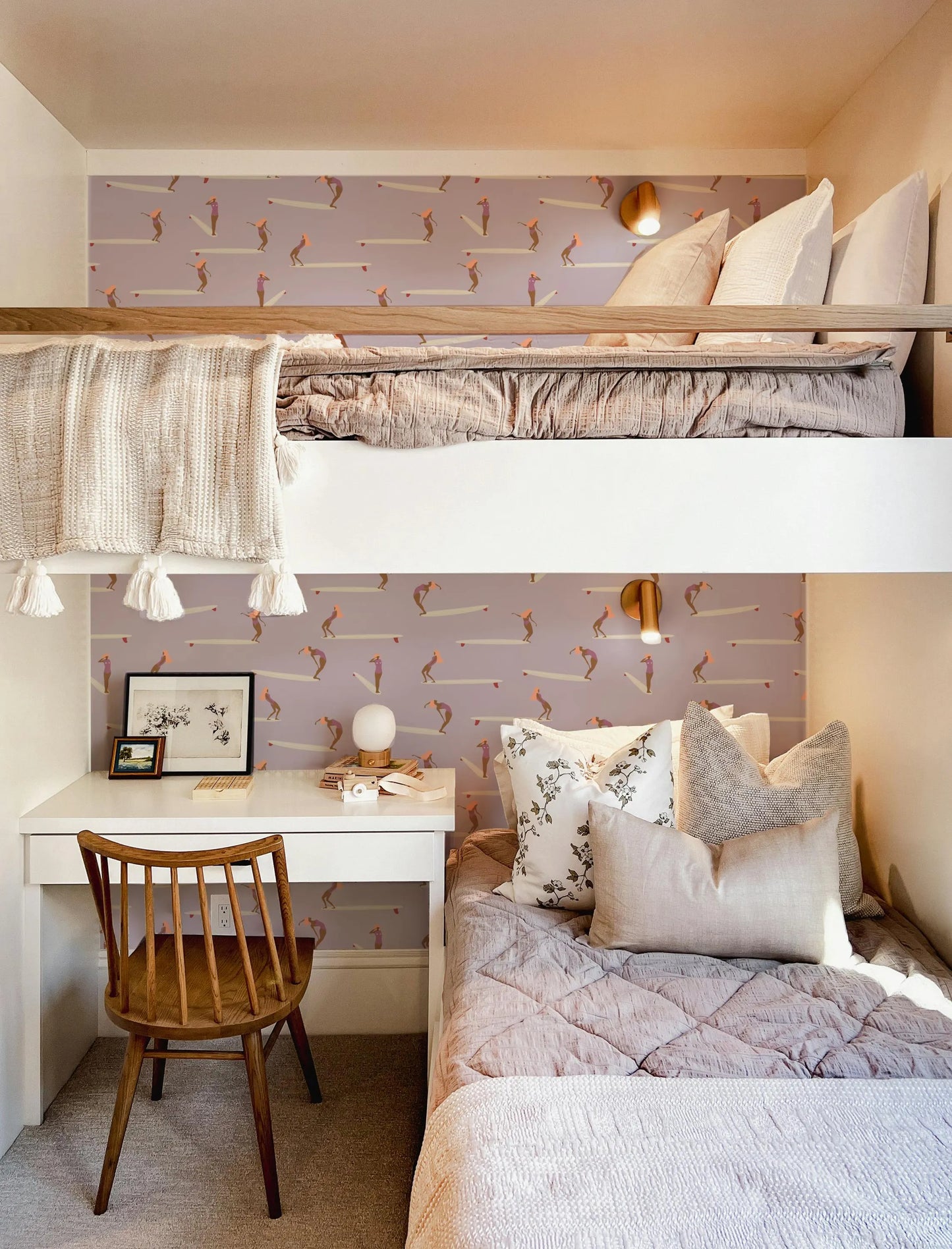 a cozy and well-furnished bedroom with a bunk bed, a desk, and a comfortable bed with decorative pillows.