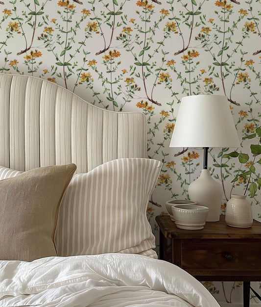 a bed with a white headboard sitting next to a lamp