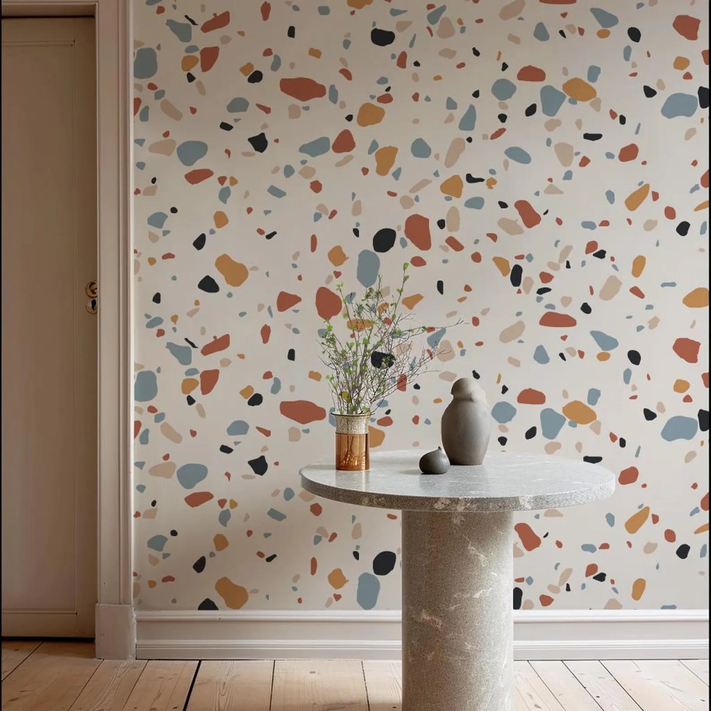 a vase with flowers on a table in front of a wall