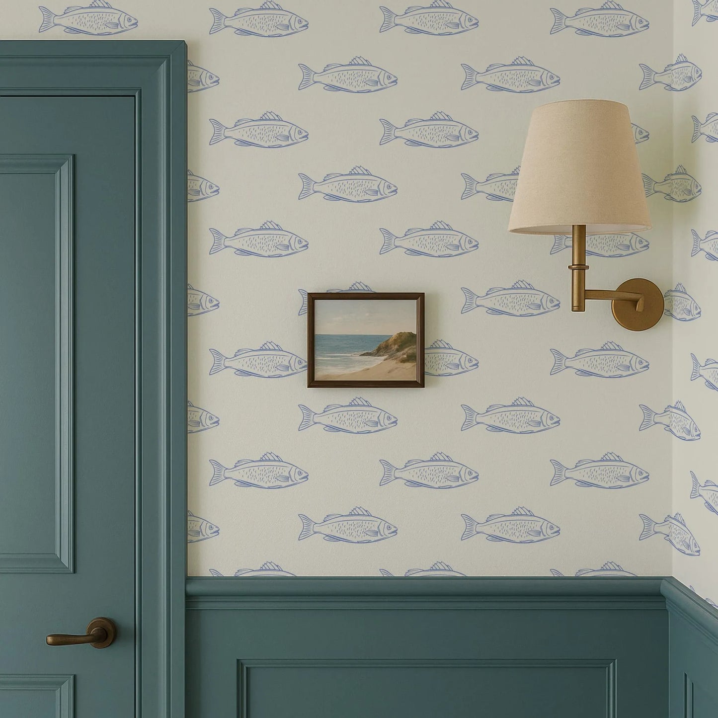 a wallpapered wall with a framed picture of a beach scene, a green door, and a wall lamp.