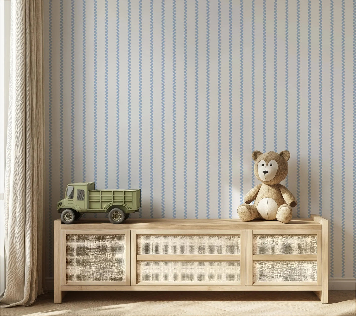 a wooden cabinet with a toy truck and a teddy bear on top, set against a striped wallpaper background.