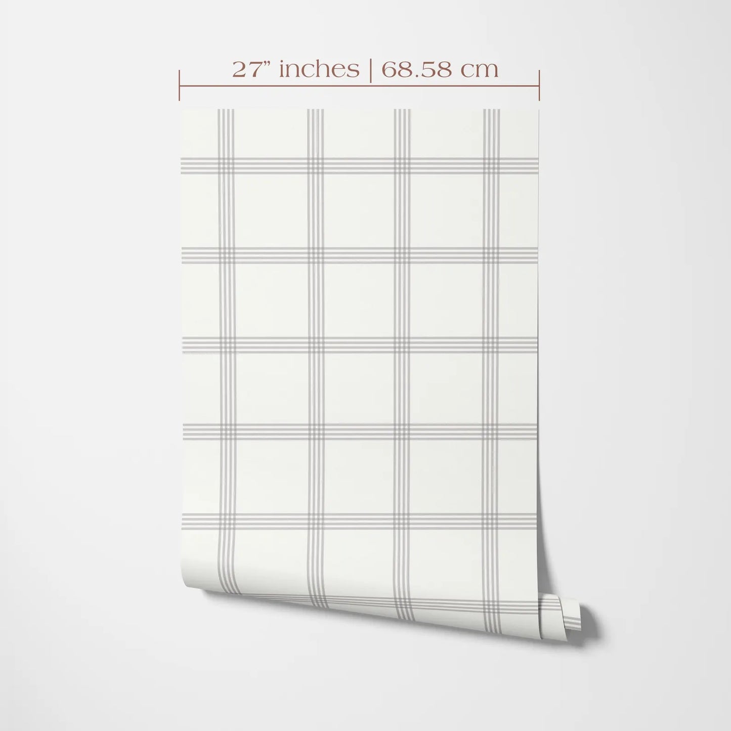 a white wall with a roll of wallpaper or a similar material displayed on it. The wallpaper has a grid pattern with vertical and horizontal lines, creating a checkered or striped appearance. The image is described as having a size of 27 inches by 68.58 centimeters.