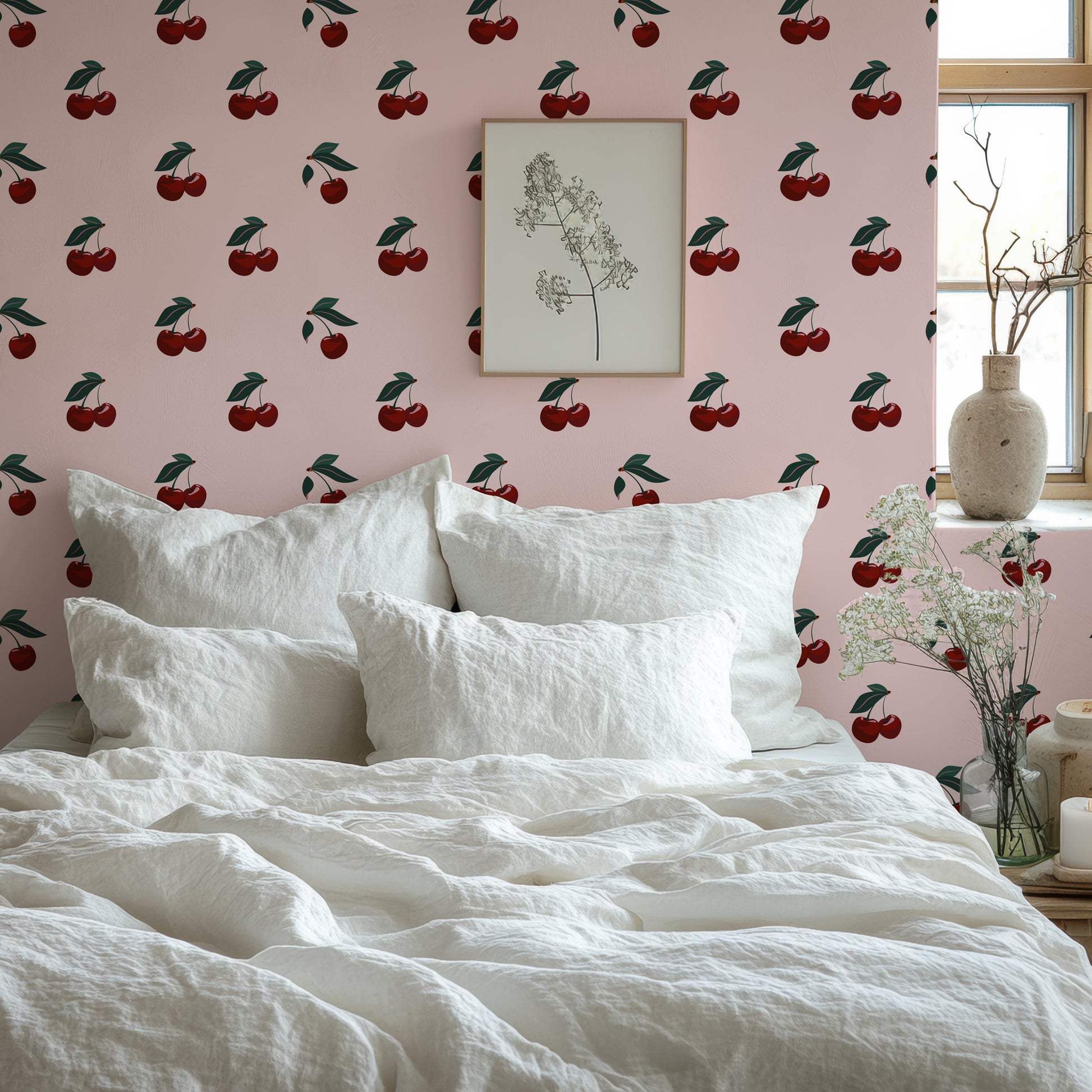 a bed with white linens and a cherry wallpaper