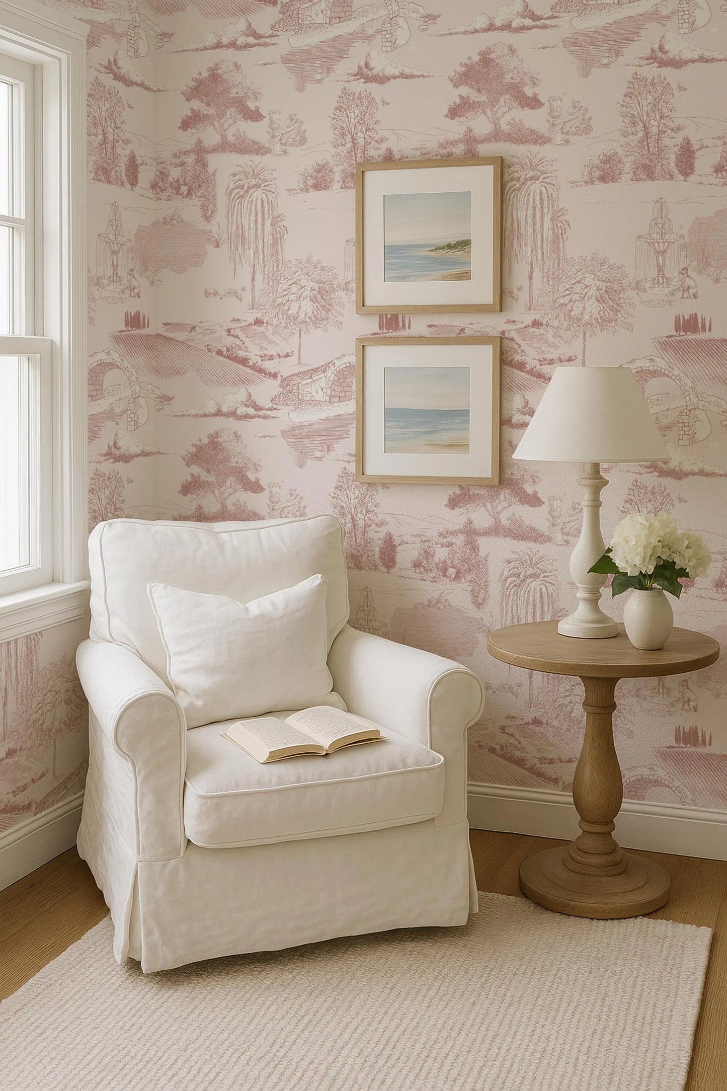 a cozy corner of a room with a white armchair, a wooden side table with a lamp, and a framed landscape painting on the wall.