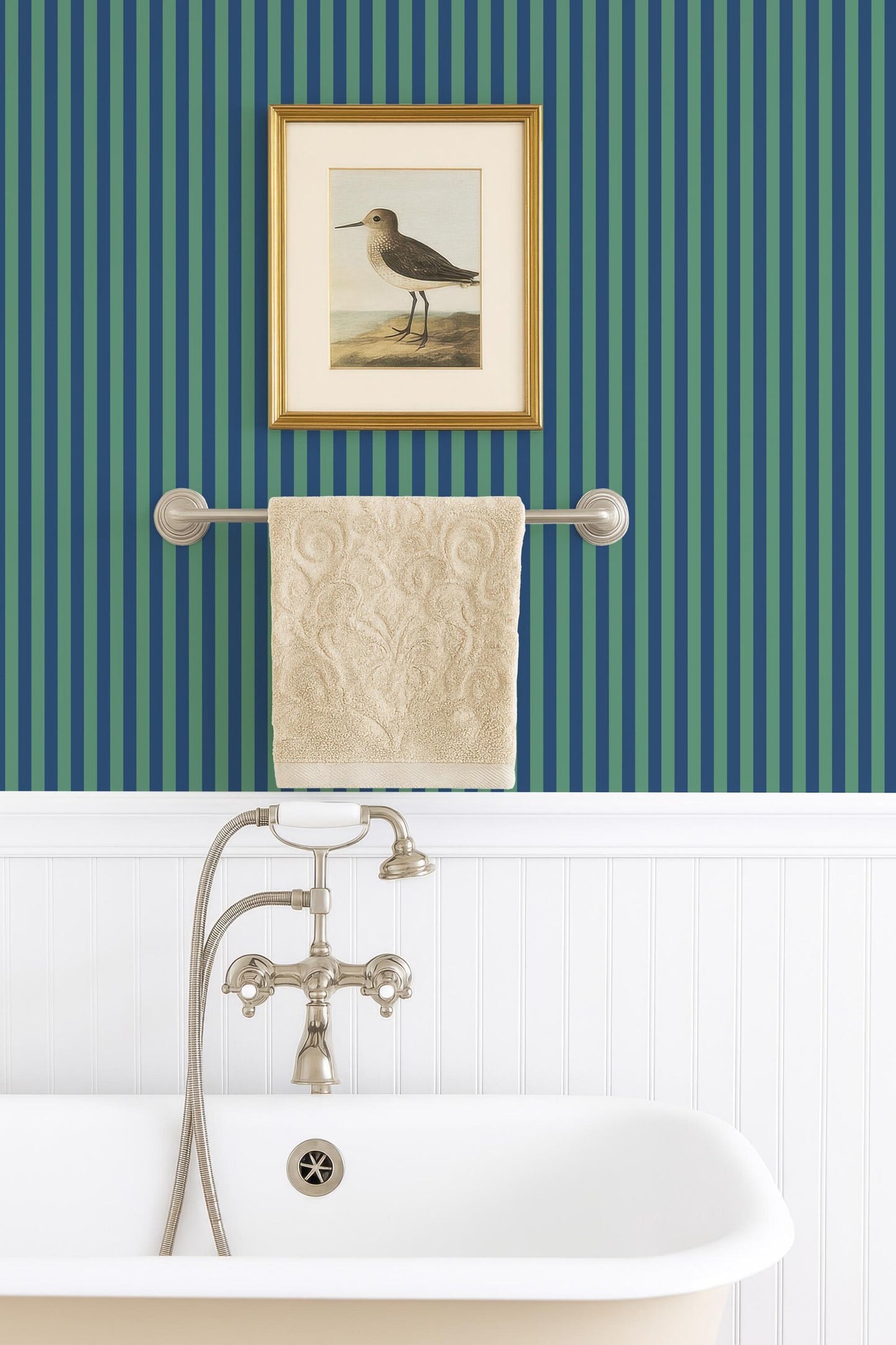 a bathroom with a white clawfoot bathtub, a towel rack, and a framed painting of a bird on the wall.