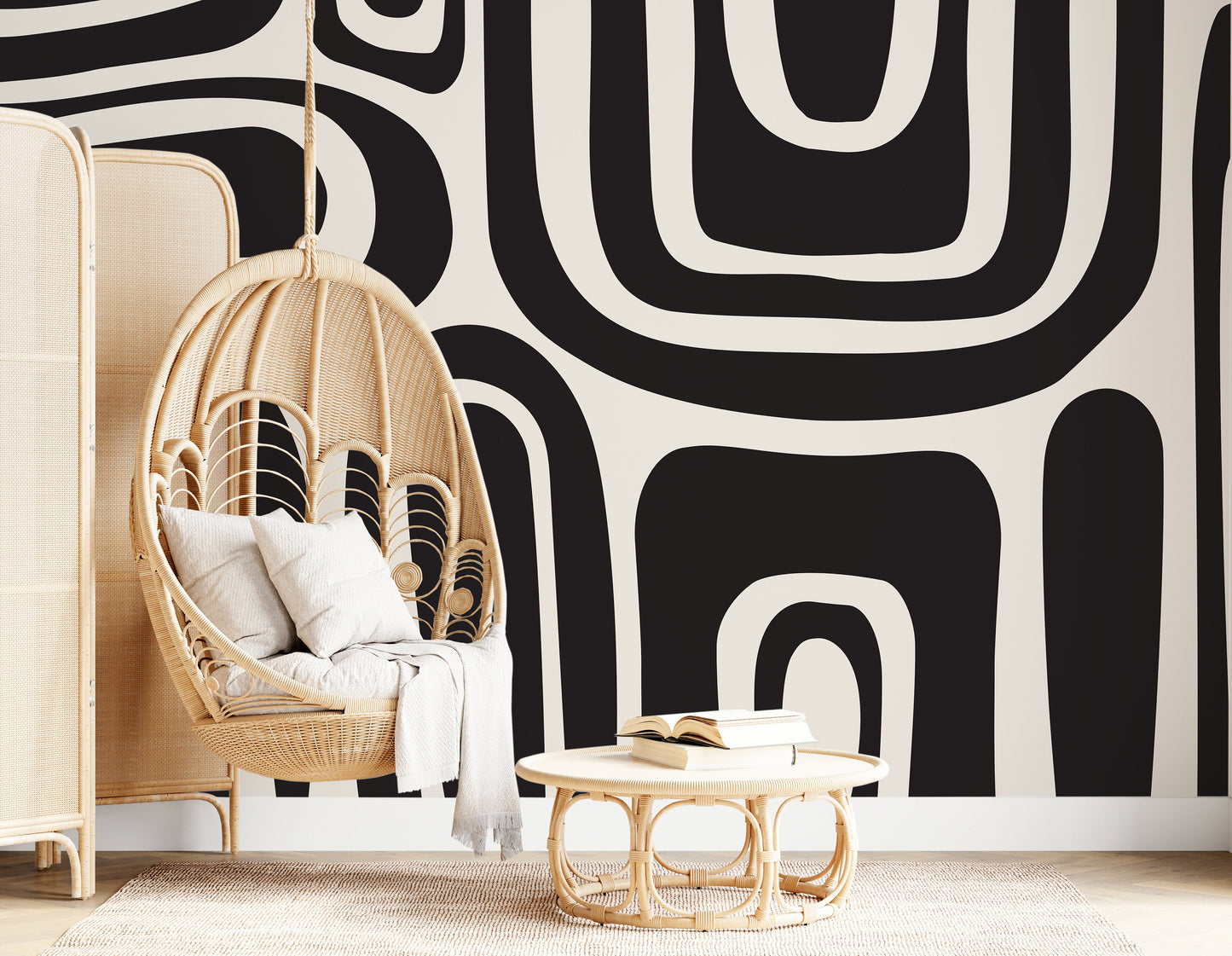 a black and white wall with a hanging chair