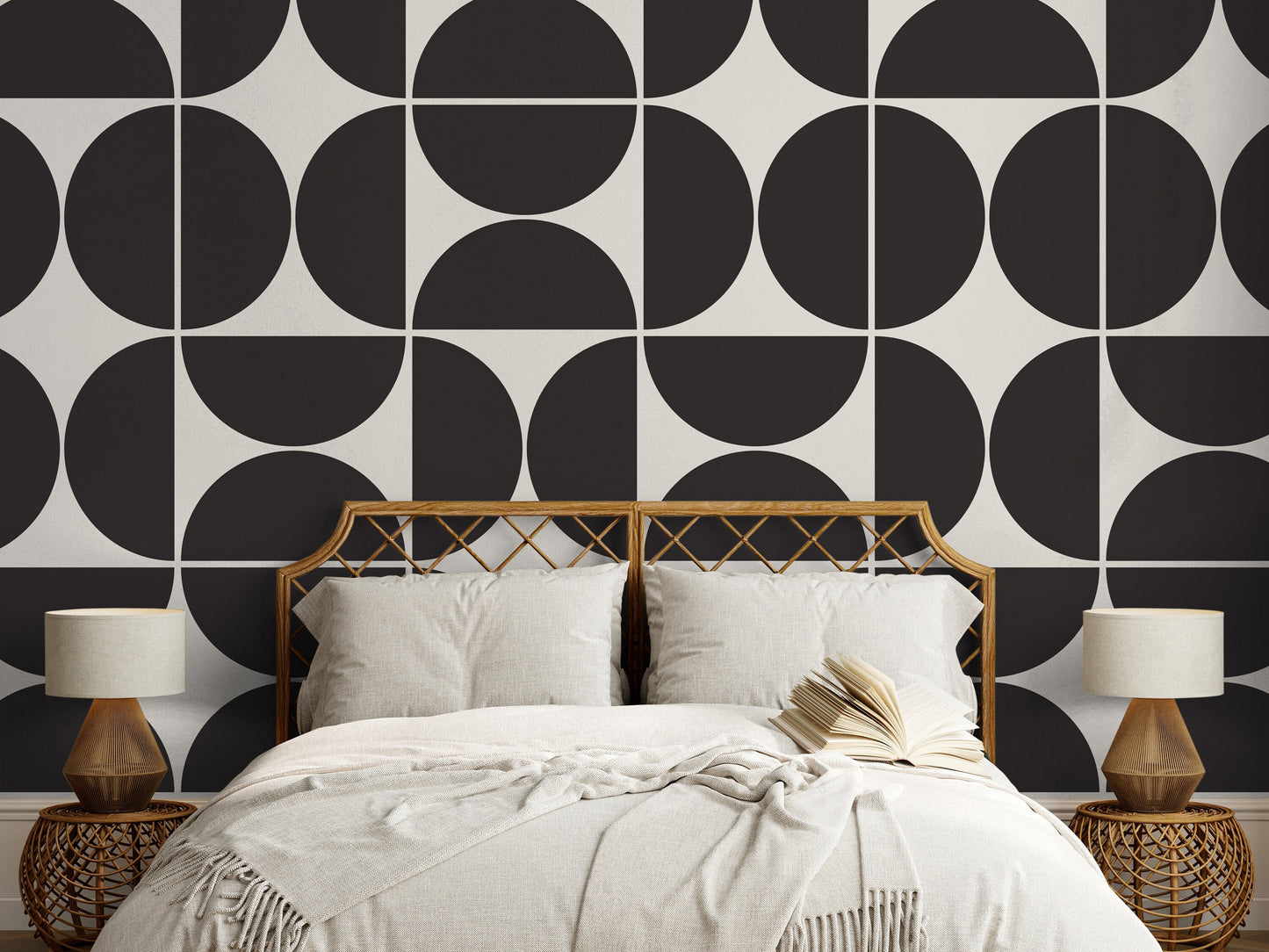 a bed with a white comforter and a black and white wall