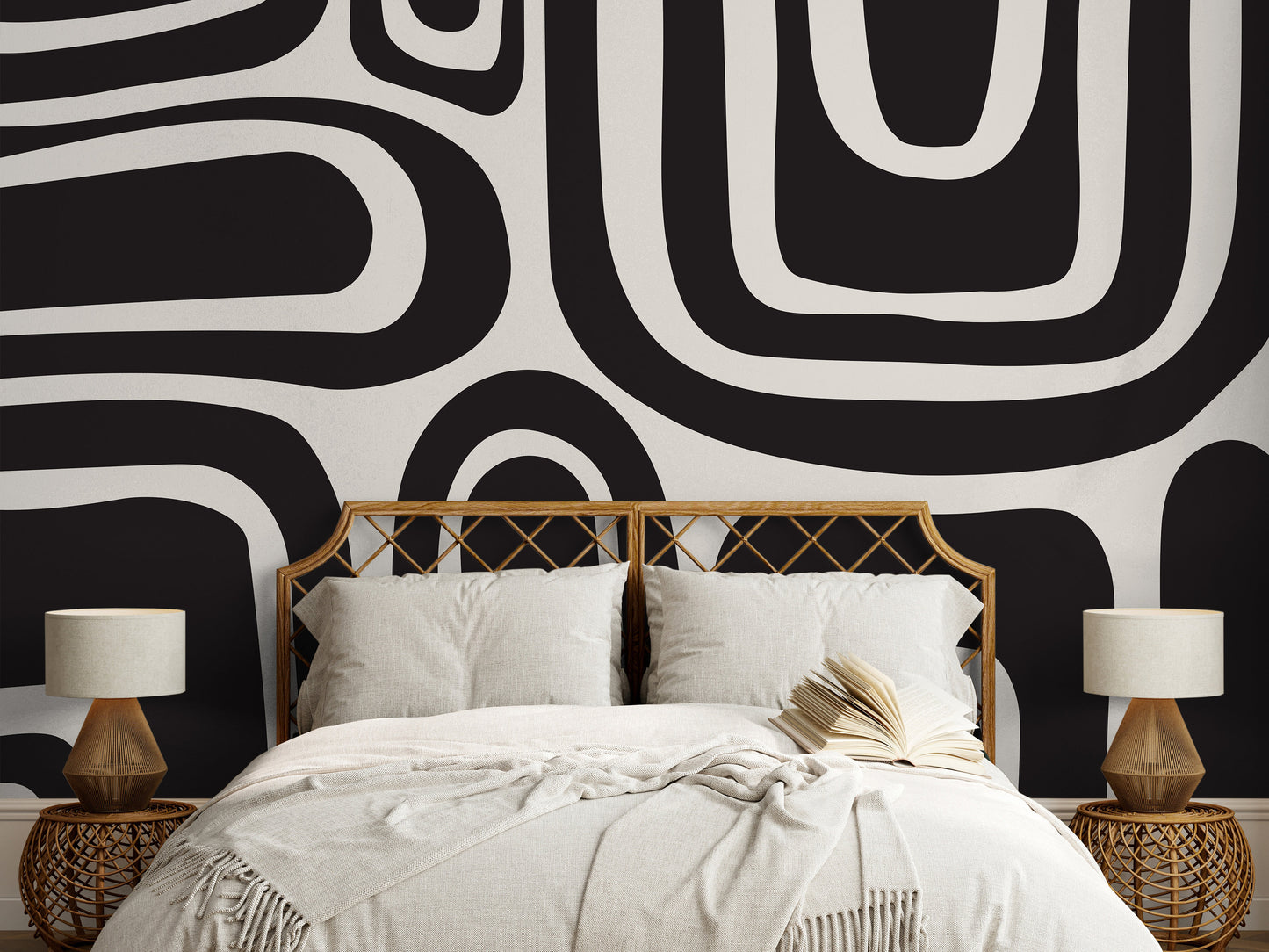 a bed with a black and white wall behind it
