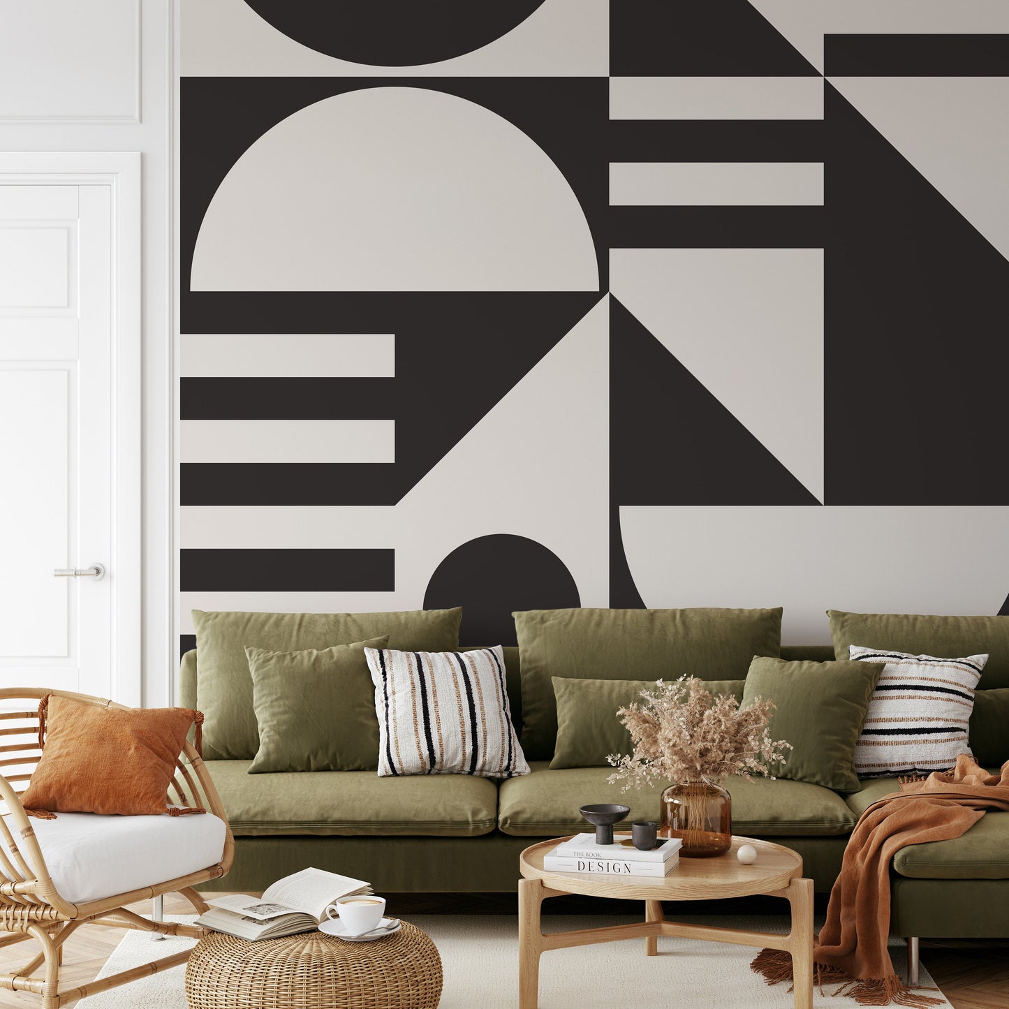 a living room with a green couch and a black and white wall