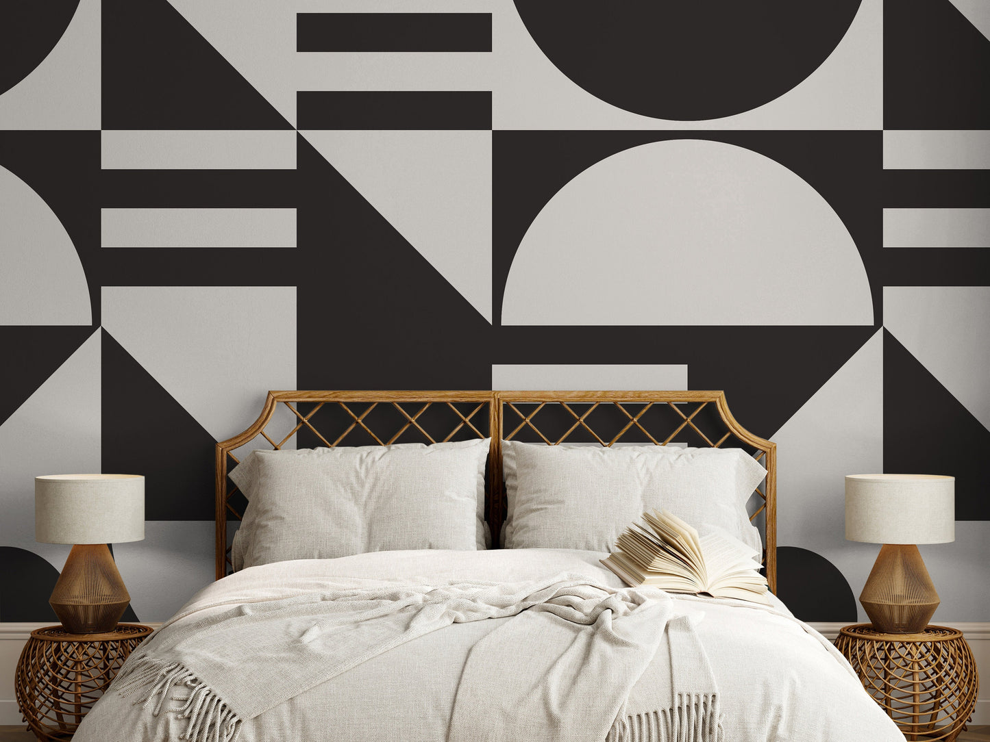 a bed with a white comforter and a black and white wall