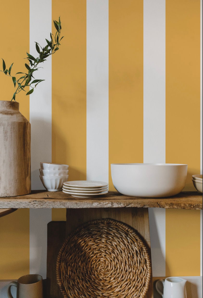 a shelf with plates, bowls and a vase on it