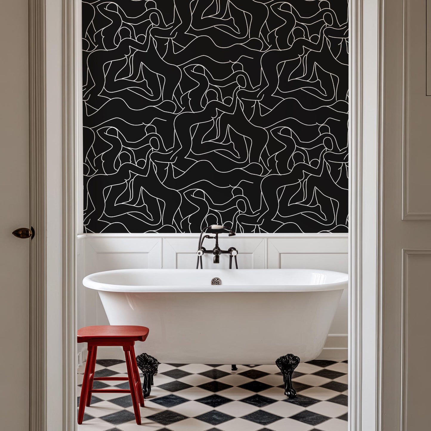 a white bath tub sitting under a black and white wall