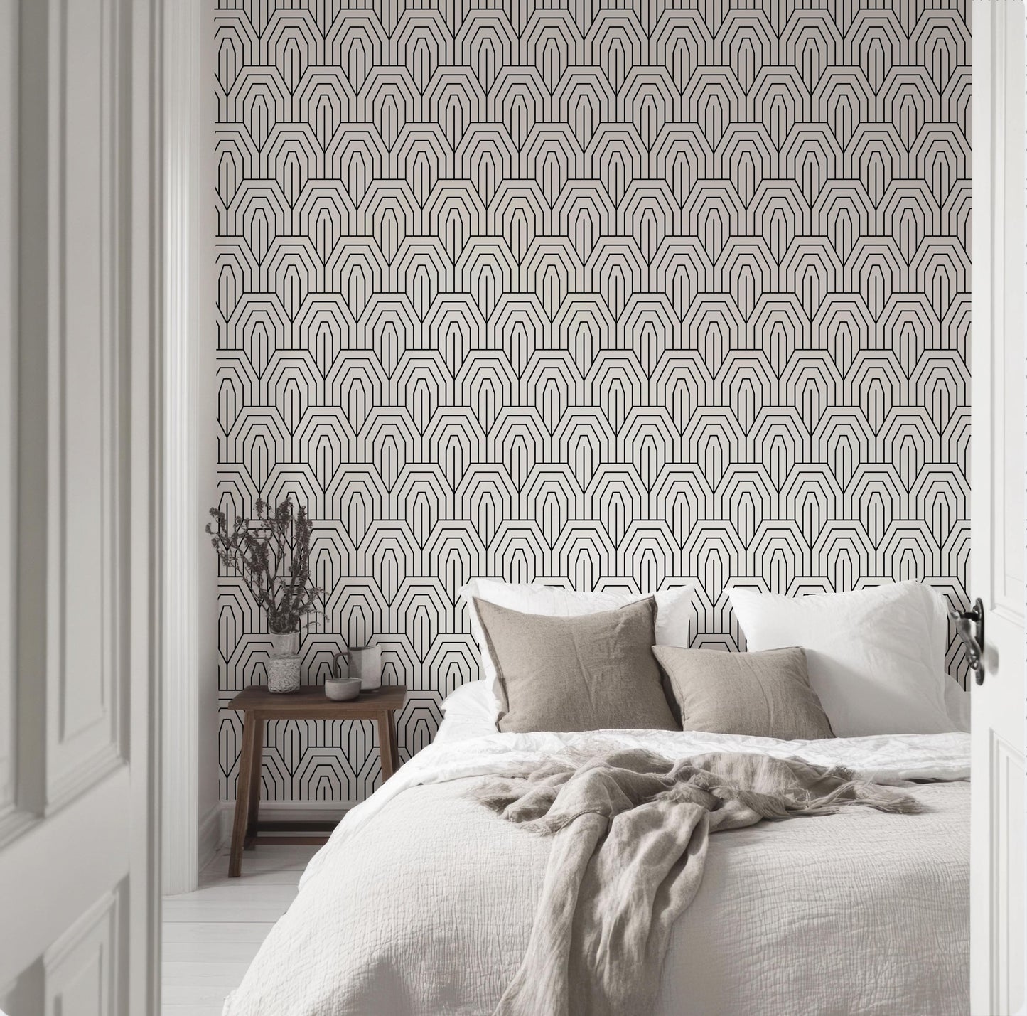 a bedroom with a white bed and a black and white wallpaper