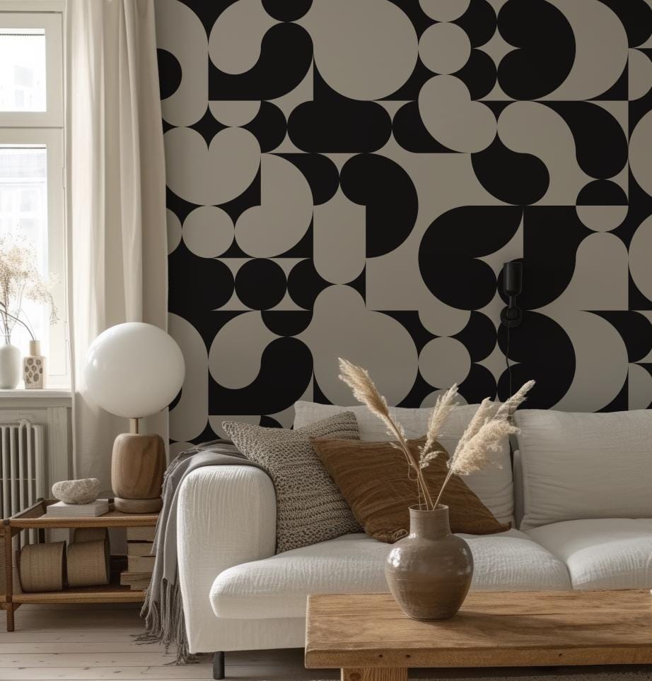 a living room with a white couch and a black and white wall