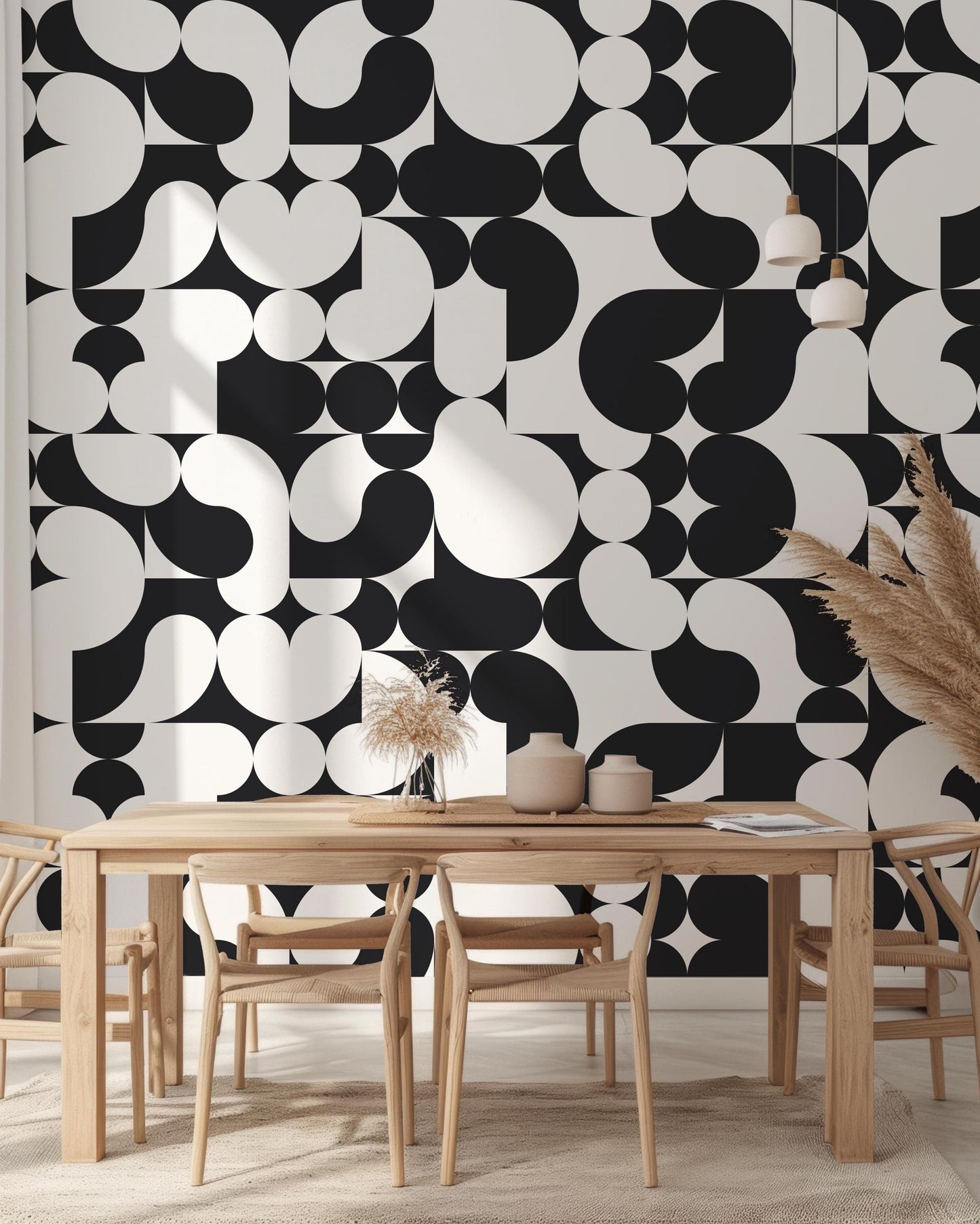 a dining room with a table and chairs in front of a black and white wall