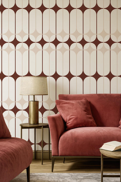 a modern living room with a red sofa, a wooden side table with a lamp, and a patterned wallpaper.