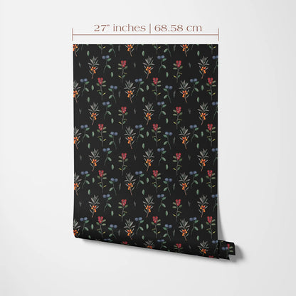 a black and white pattern of colorful flowers and leaves on a wall.