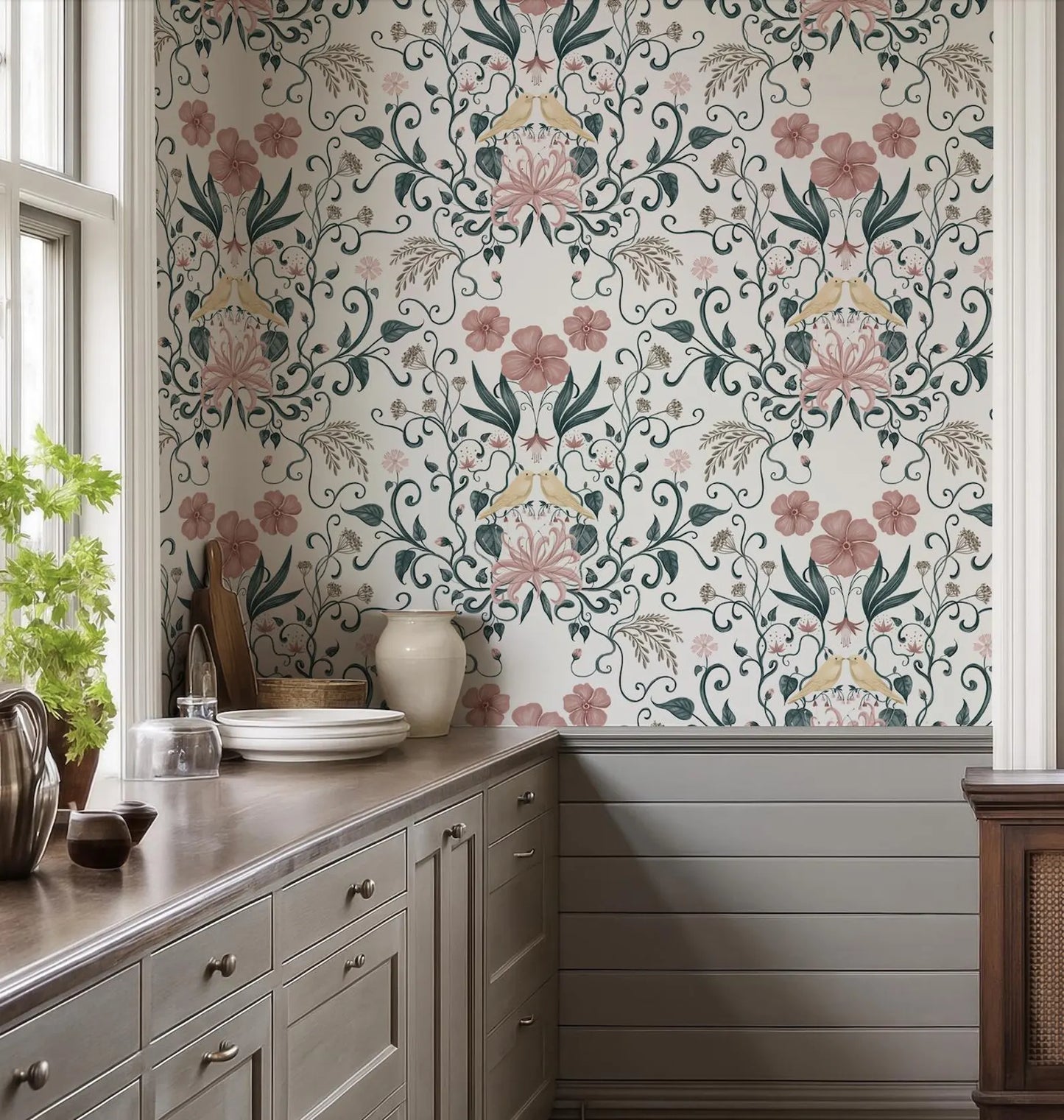a kitchen with a floral wallpaper pattern, a wooden cabinet, and a countertop with various kitchen items such as a vase, a bowl, and a plate.