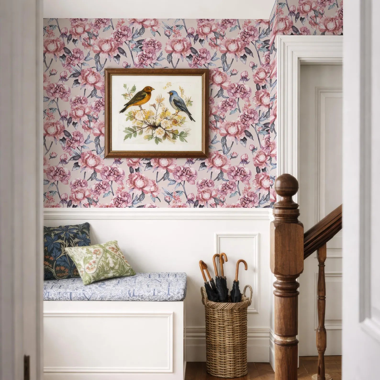 a cozy and charming interior with a floral wallpaper, a wooden staircase, a bench, and a wicker basket filled with umbrellas.