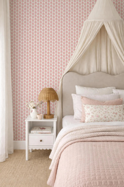 a cozy and inviting bedroom with a canopy bed, a white nightstand, and a pink and white floral wallpaper.