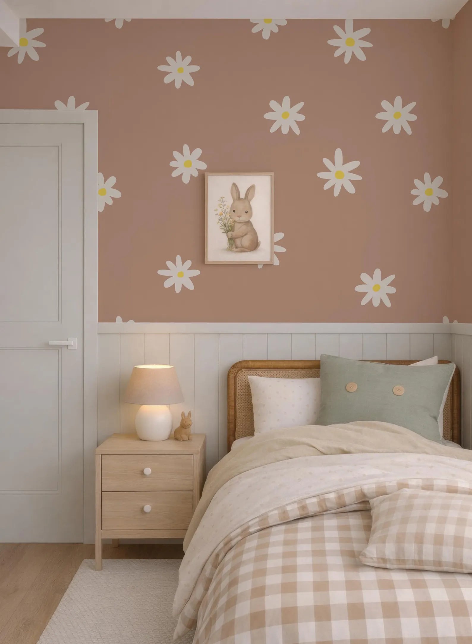 a cozy bedroom with a bed, nightstand, and wall art featuring a bunny. The walls are decorated with white flowers, creating a cheerful and inviting atmosphere.