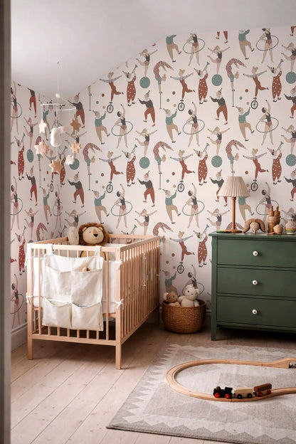 a nursery room with a wooden crib, a green dresser, and a toy train on a rug. The walls are decorated with a pattern of circus performers and circus-related imagery.