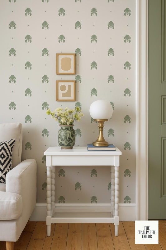 a cozy living room with a white side table, a lamp, a vase with flowers, and a framed picture on the wall.