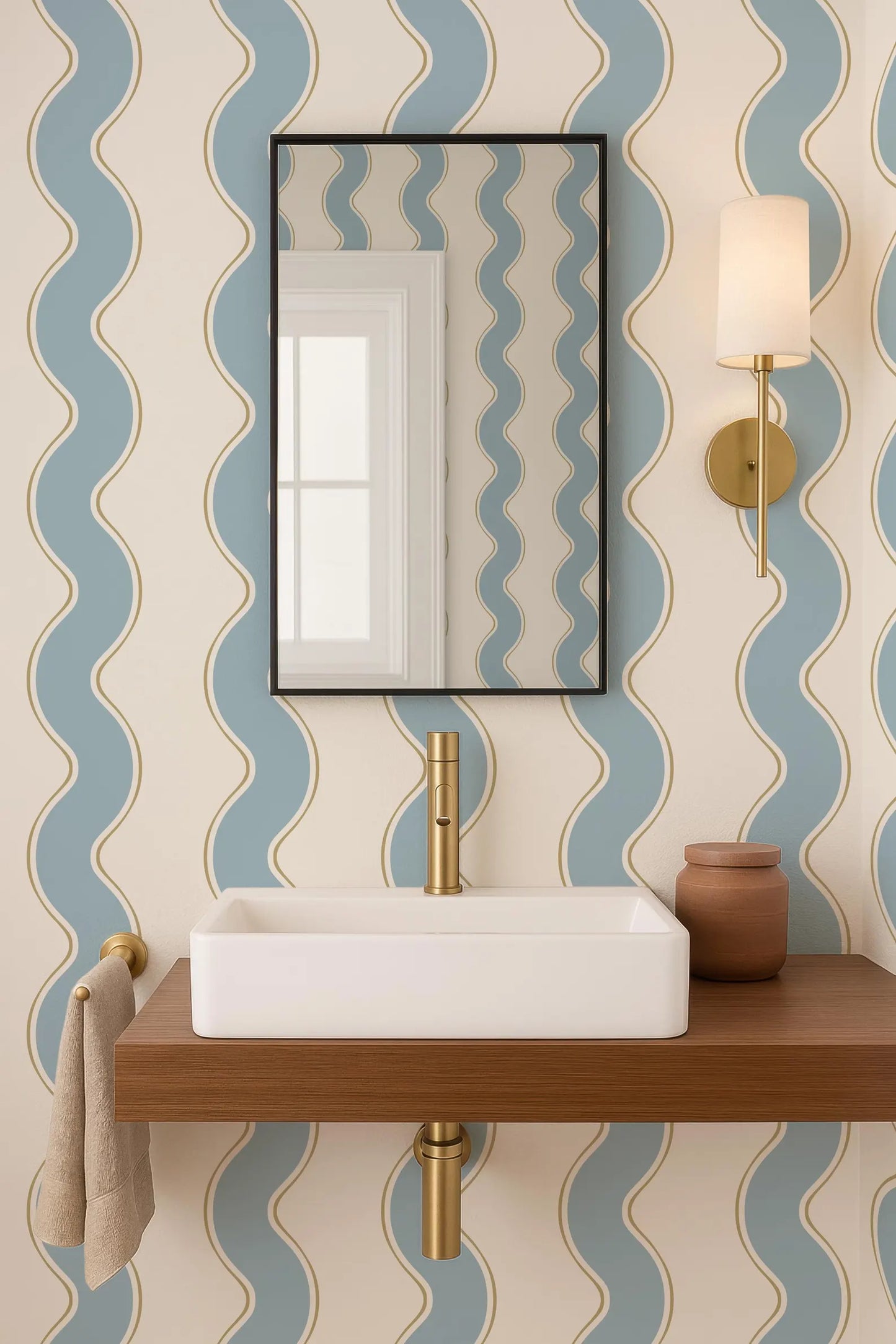 a bathroom with a white rectangular sink, a mirror above it, and a wooden shelf below the sink. The walls are decorated with a blue and white striped pattern, and there is a gold-colored light fixture on the wall.