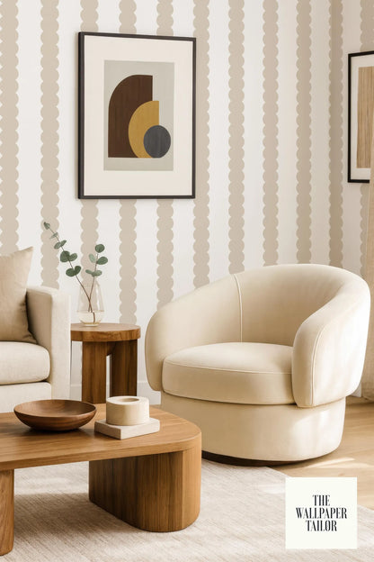 The image showcases a modern living room with a beige armchair, a wooden coffee table, and a framed abstract artwork on the wall.