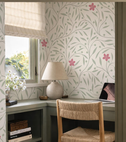 a cozy and well-organized home office space with a desk, a lamp, a laptop, and a window with a view of trees.