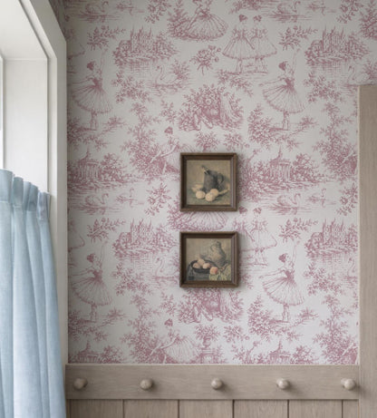 a wall with a pink and white wallpaper pattern, and two framed pictures hanging on it.