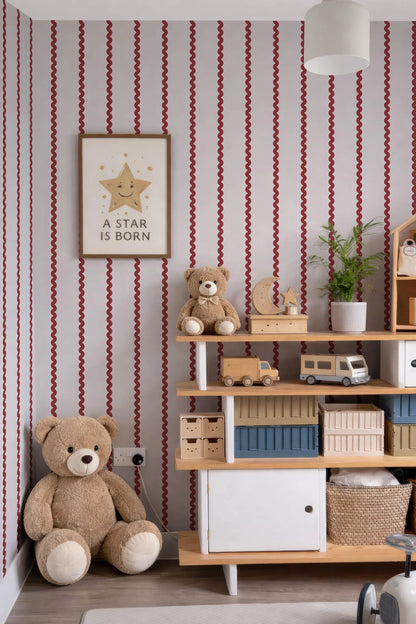 a cozy and colorful children's bedroom with a teddy bear, a framed quote, and various toys and storage units.