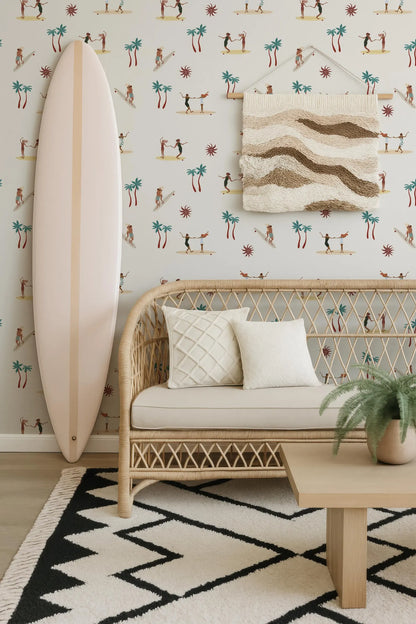 a living room with a wicker bench, a surfboard, and a woven wall hanging. The wall hanging depicts palm trees and surfers. The room has a geometric rug and a potted plant, creating a beach-inspired atmosphere.