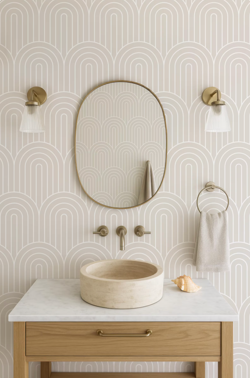 a bathroom with a white marble sink, a round mirror, and two wall sconces. The walls are decorated with a repeating pattern of arches, creating a modern and stylish aesthetic.