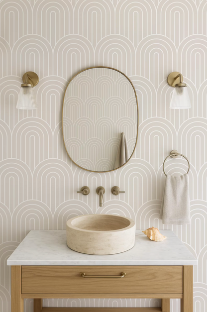 a bathroom with a white marble sink, a round mirror, and two wall sconces. The walls are decorated with a repeating pattern of arches, creating a modern and stylish aesthetic.