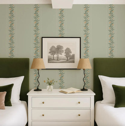 a cozy bedroom with a white dresser, two green headboards, and a framed landscape painting above the dresser. The room has a harmonious color scheme with the green walls and white furniture.