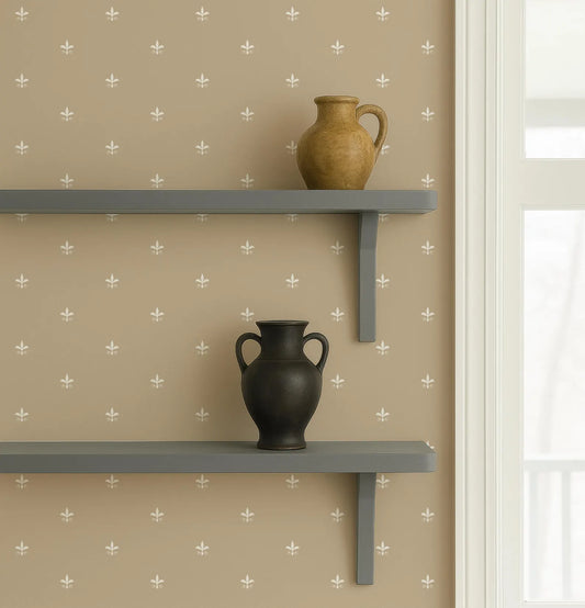 two black vases placed on a gray shelf against a beige wall with a repeating pattern of white flowers.