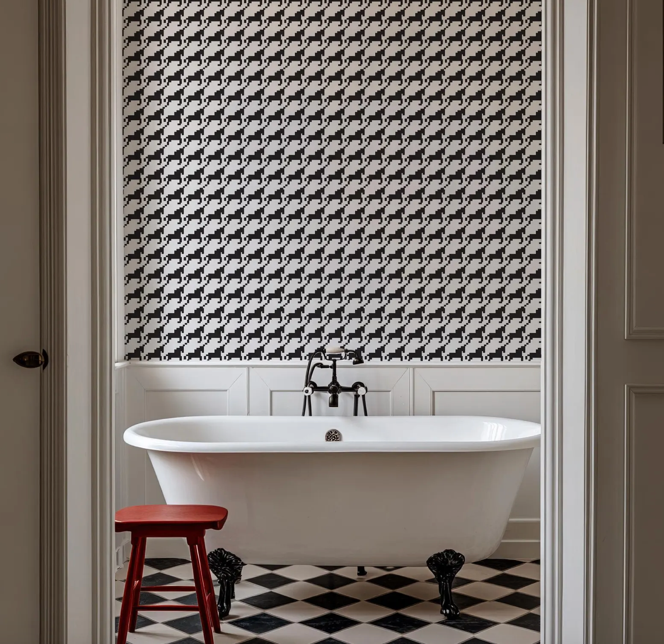 a bathroom with a black and white wallpaper and a claw foot bathtub