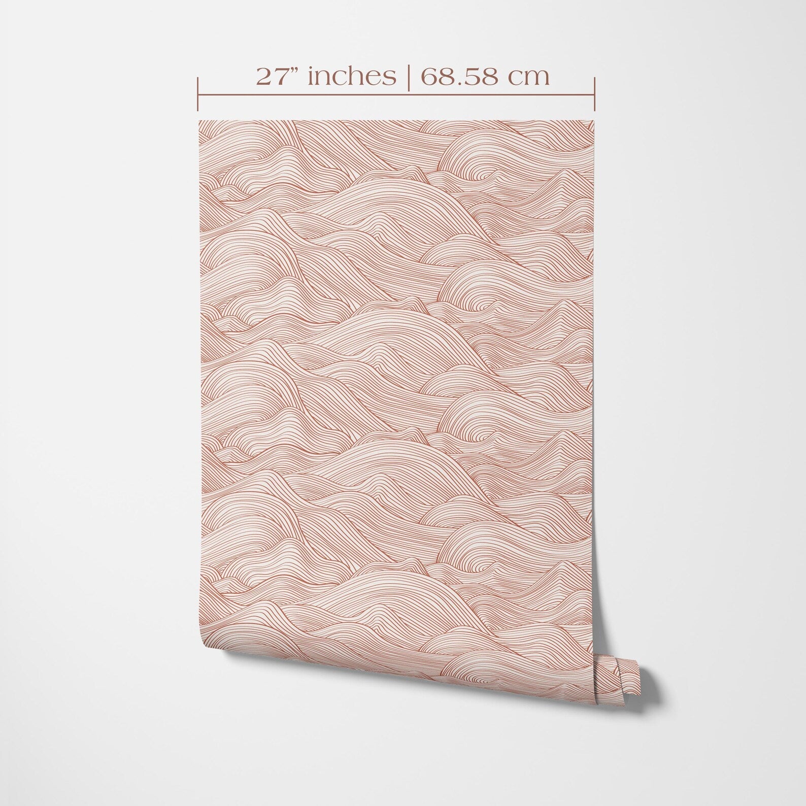 a patterned wallpaper or wall covering with a repeating wave-like design in shades of pink and orange. The wallpaper is rolled up and displayed against a white background, with measurements indicating it is 27 inches (68.58 cm) wide and 68.58 cm tall.