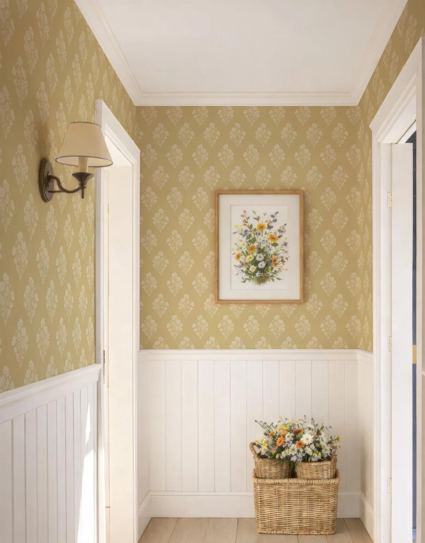a hallway with a wicker basket filled with flowers placed in the corner, and a framed floral artwork hanging on the wall above it.