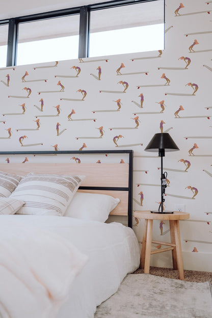 a bedroom with a bed, a nightstand, and a patterned wallpaper.