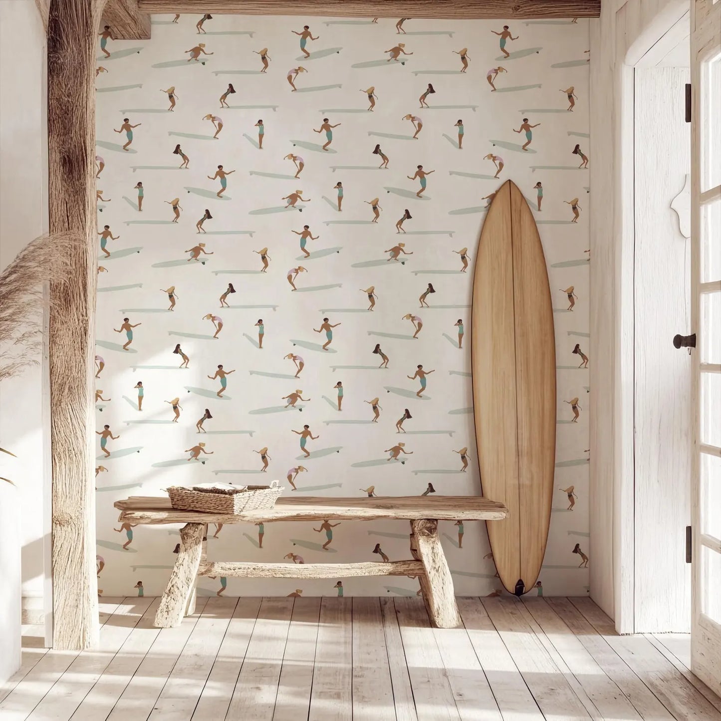 a wooden bench with a wicker basket on it, positioned in front of a wall with a repeating pattern of surfers riding waves. A surfboard is leaning against the wall next to the bench.